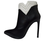 Black high-heeled boot with white zigzag pattern on a white background
